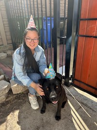 Maggie is taking a picture with her dog Bochi on their birthdays